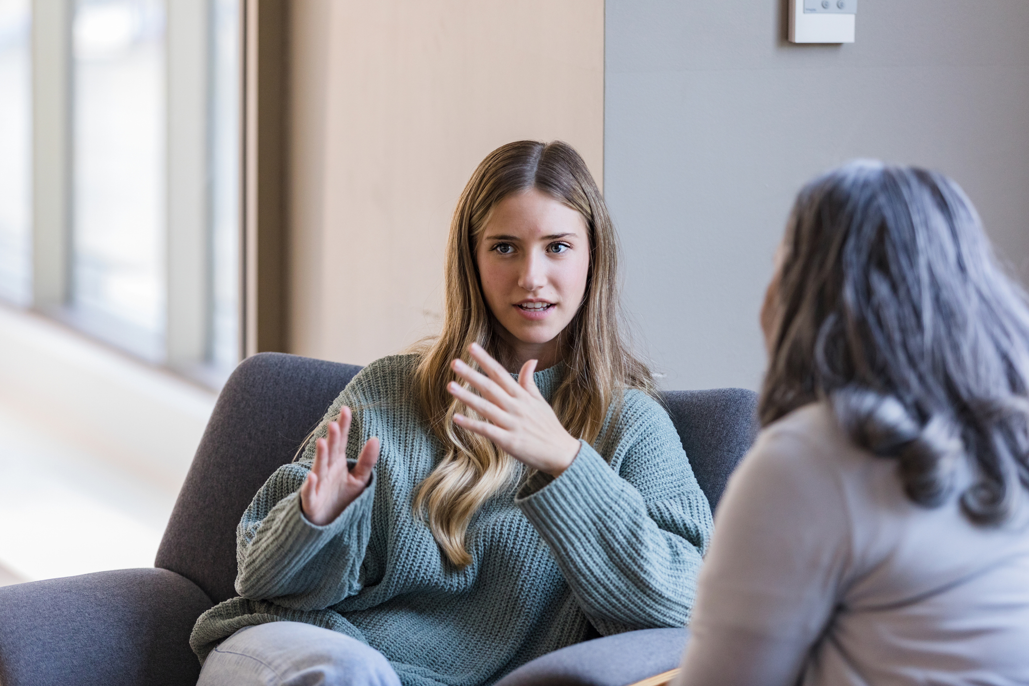 Young adult university student talks with her peer iStock 1459782858